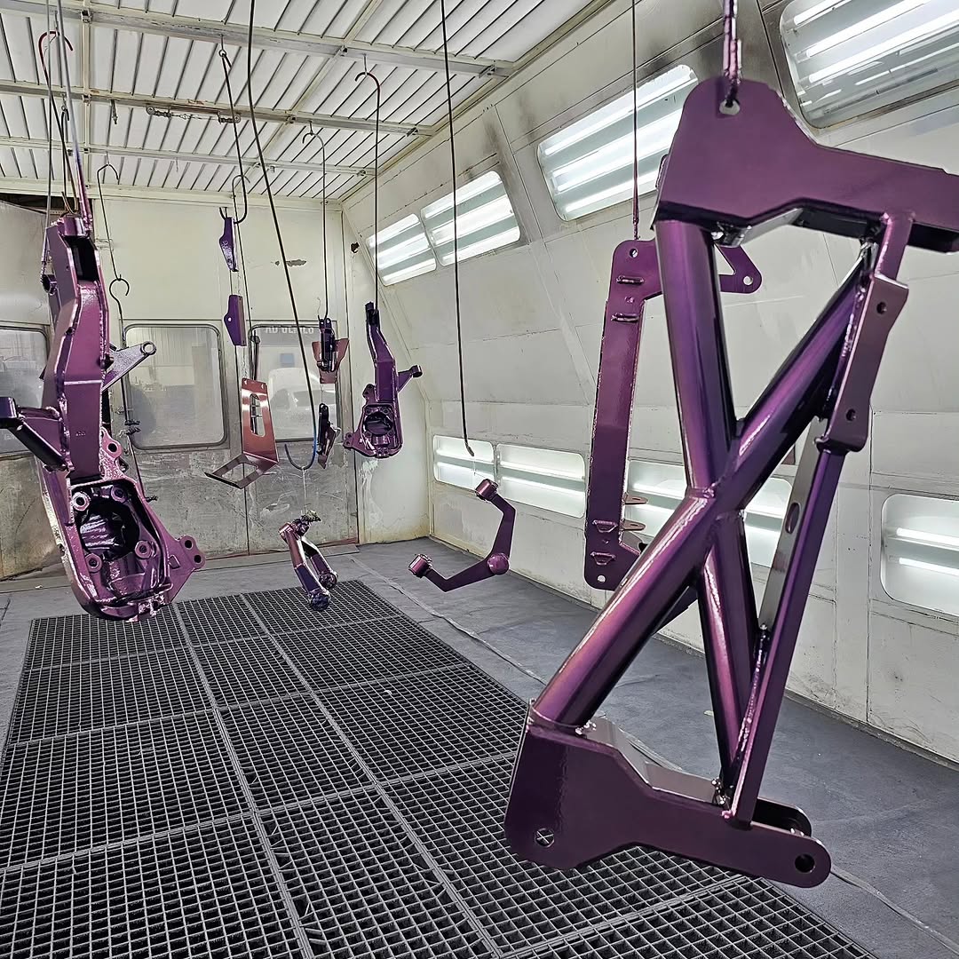 Custom color-shift purple suspension components in the booth